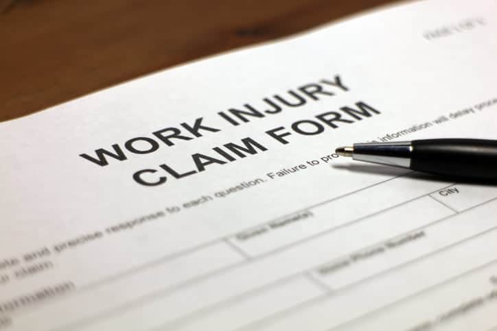Someone filling out work injury claim form